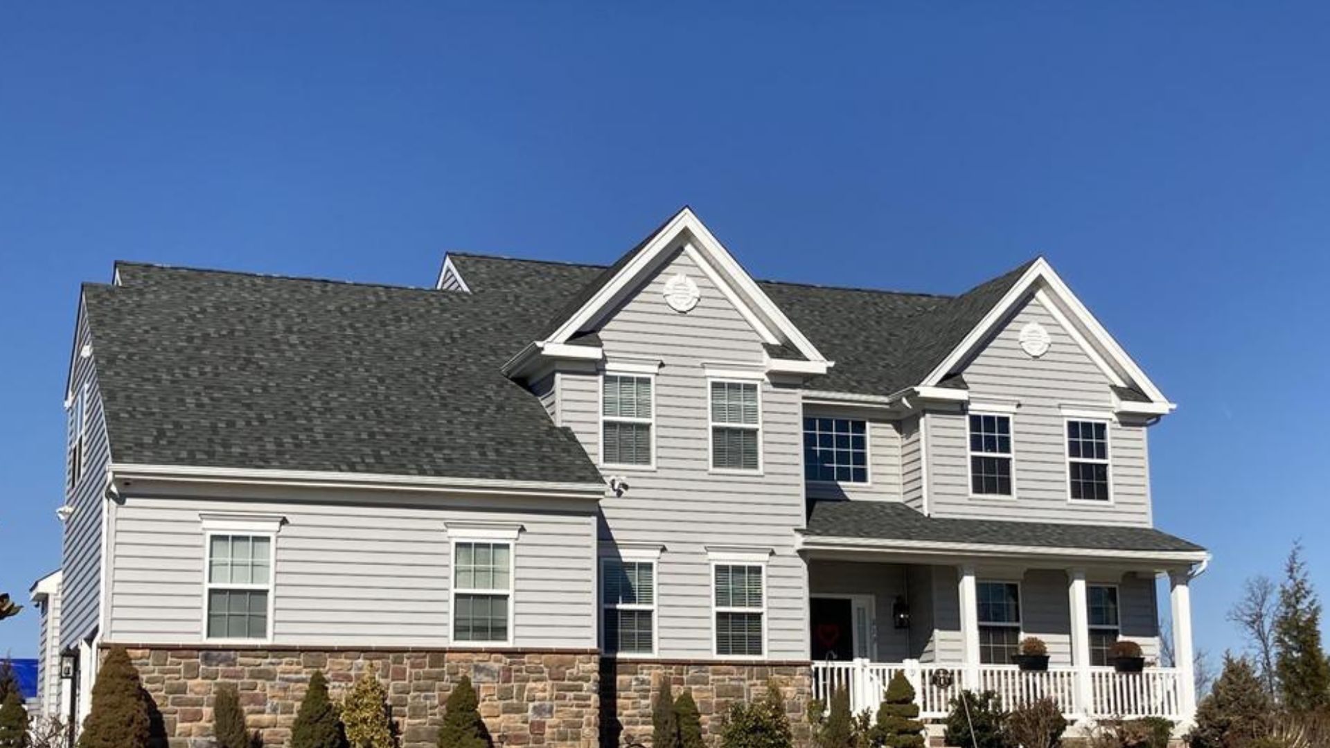 house with new grey roof by sure roofing